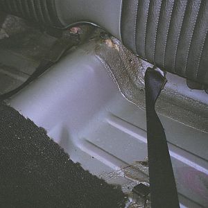 back seat with insulation mat removed, the original factory primer and paint