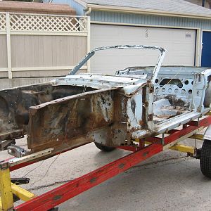 Mounted on a chassis rack for restoration. Sandblasting after tear-down.