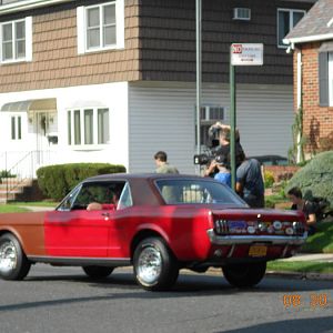 Close-up of drive by with film crew.