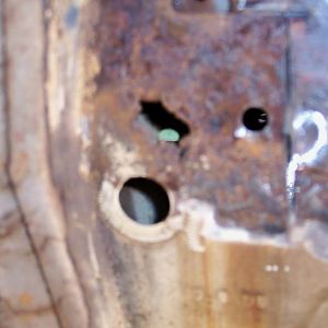8/17/16 Rust through spot just below l/s upper door hinge.
