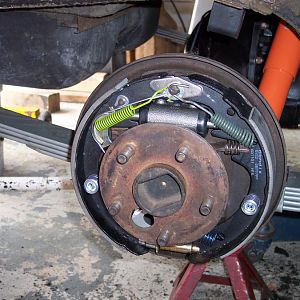 4/15/17 installed both assembled backing plates on rear end housing & installed both axles.