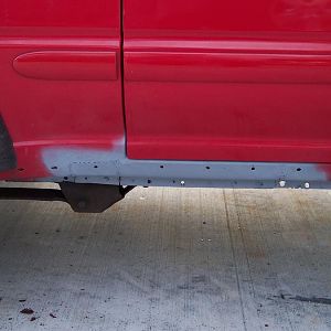 New lower quarter welded in & primed & holes for rocker molding drilled.