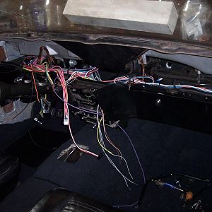 12/16/17 Mounted the fuse box, hooked up head light, wiper, door jamb, dimmer, & ignition switches, cigarette lighter, ran the wires to the rear side